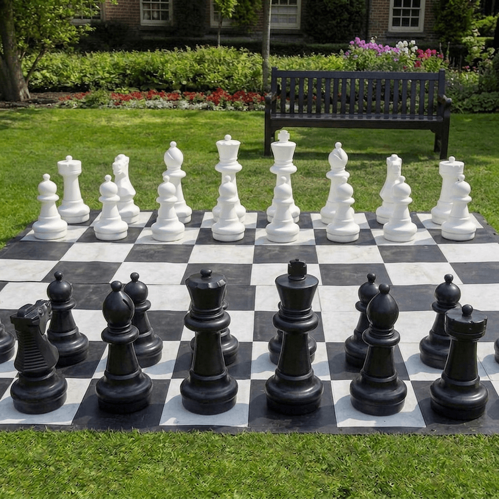 Giant outdoor chess set arranged on a garden lawn